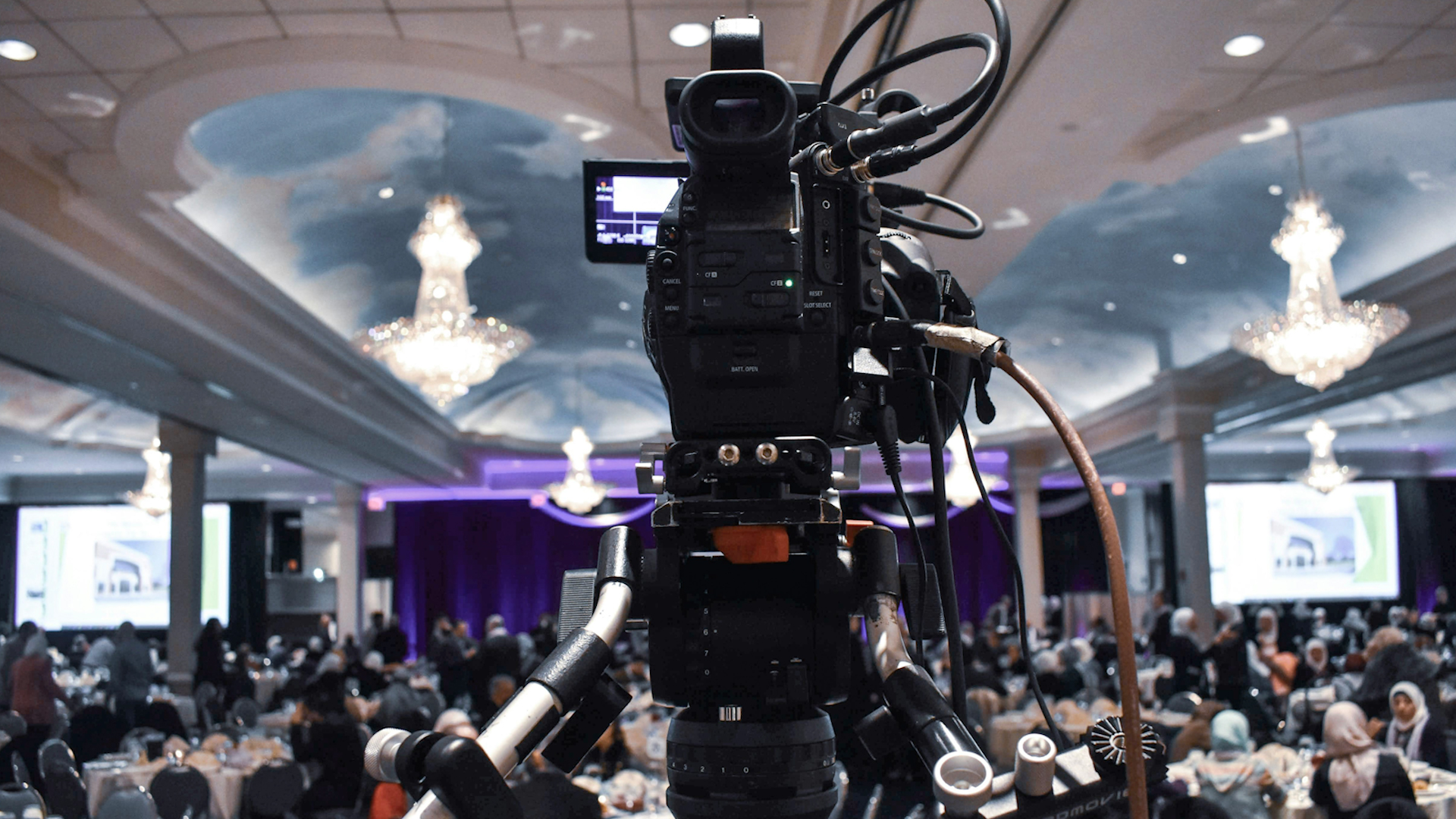 Camera on a tripod with camera controls in a live conference event