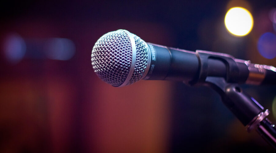 SM58 microphone on a stand with soft shallow focus