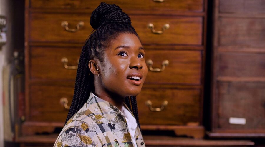 actress with braid in front of mahogany cabinets