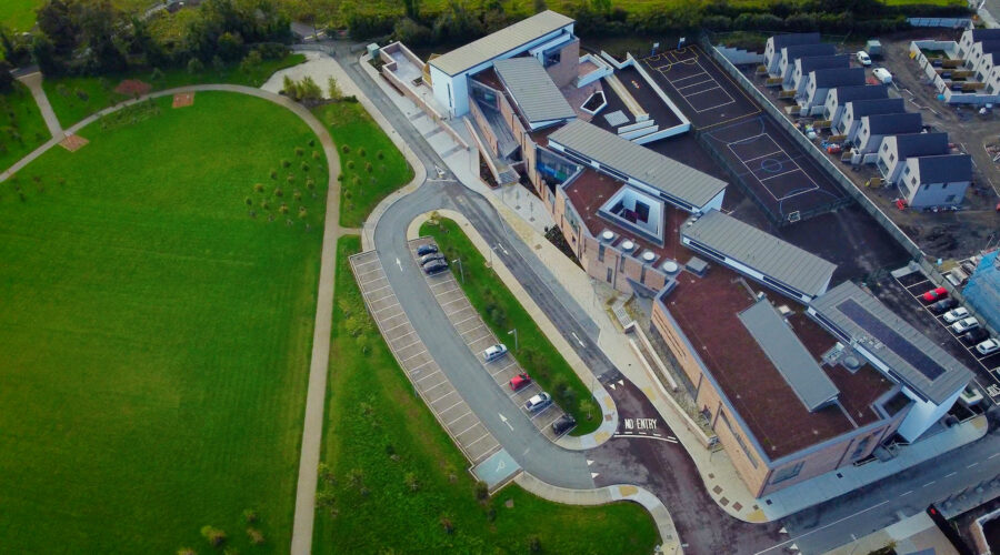 Aerial drone view of a housing estate and school