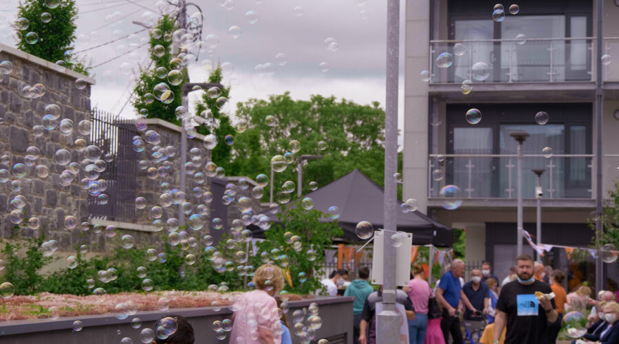 bubbles floating over a crowd at an outdoor event in Dublin