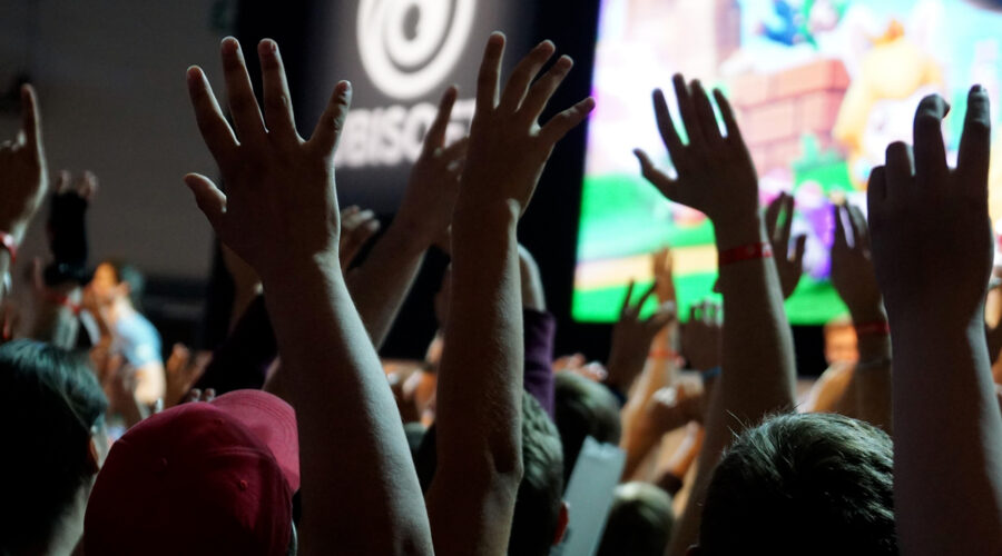 crowd applauding and waving at a live conference event