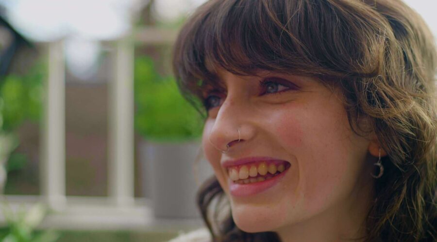 close up of a young woman smiling with nose rings