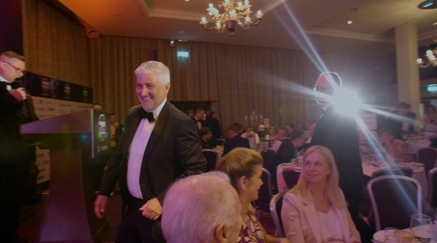 man walking up to stage during an awards show