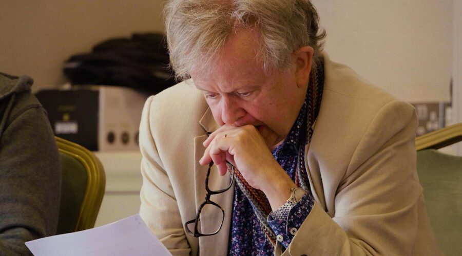 man reading a script with glasses