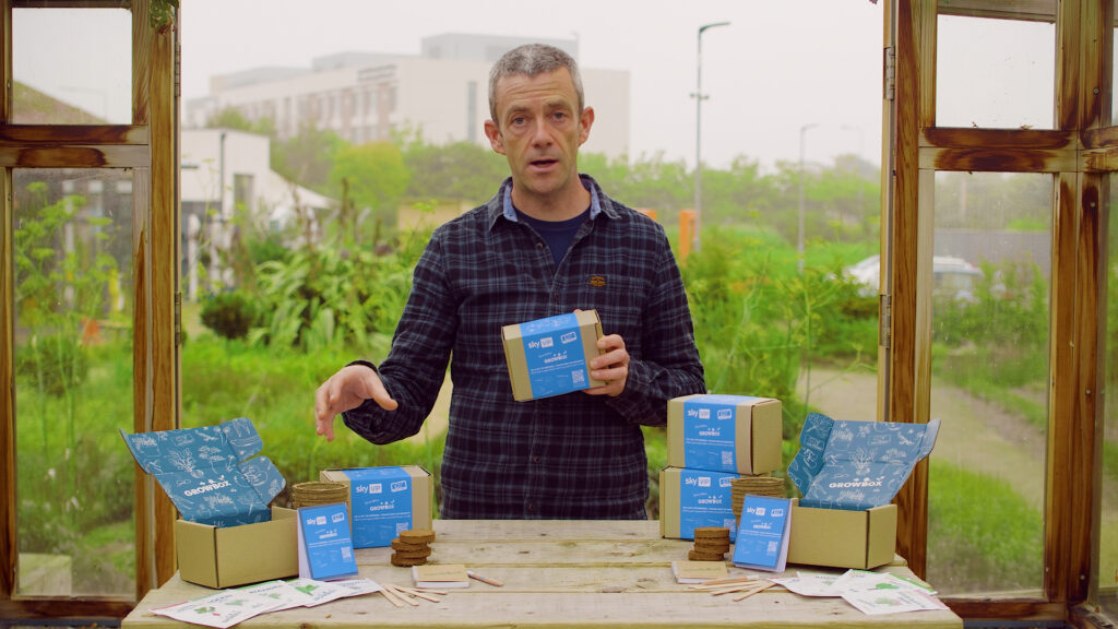 Man demonstrating gardening products talking to camera using a teleprompter