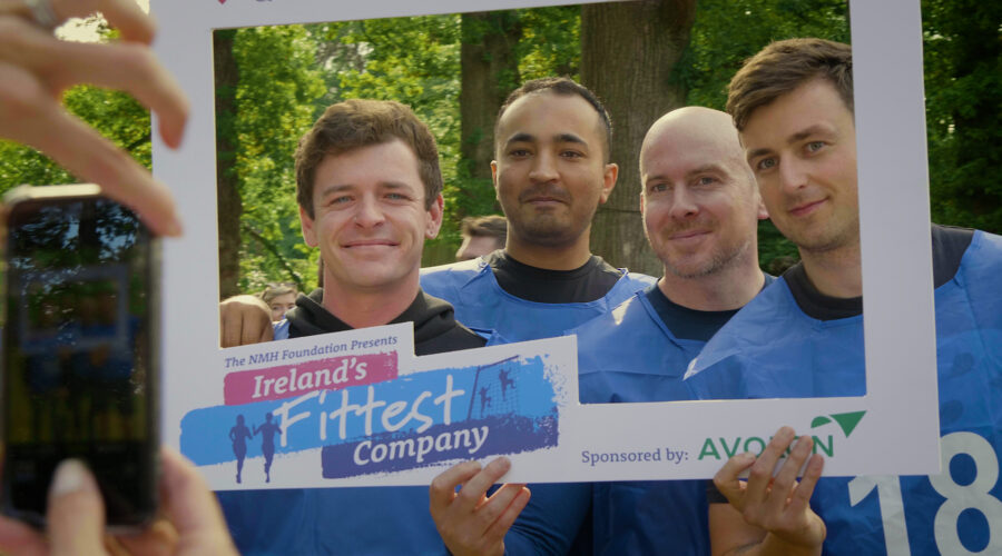 group of people holding a branded photo frame for social media marketing