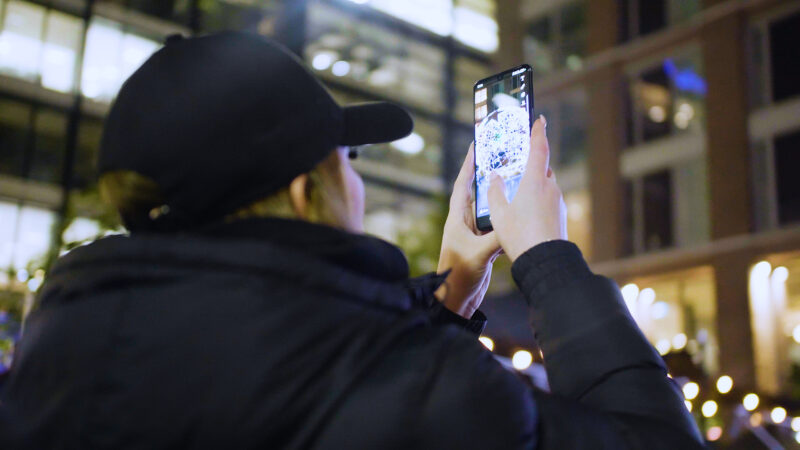 person-in-hat-uses-iphone