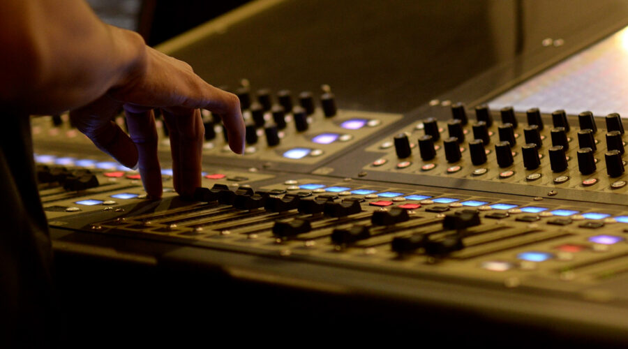 sound engineer operating a sound mixing desk