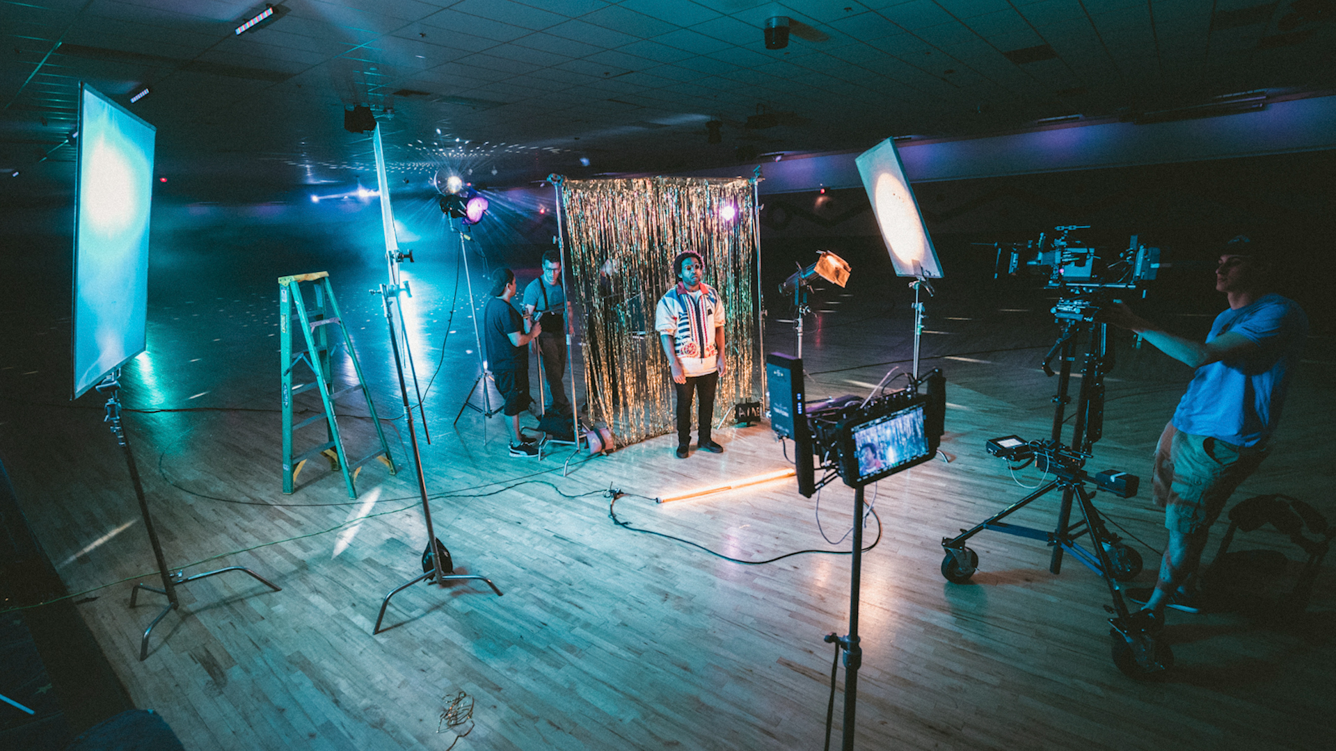 video production with lights, bounce boards, flags, cinema camera and crew