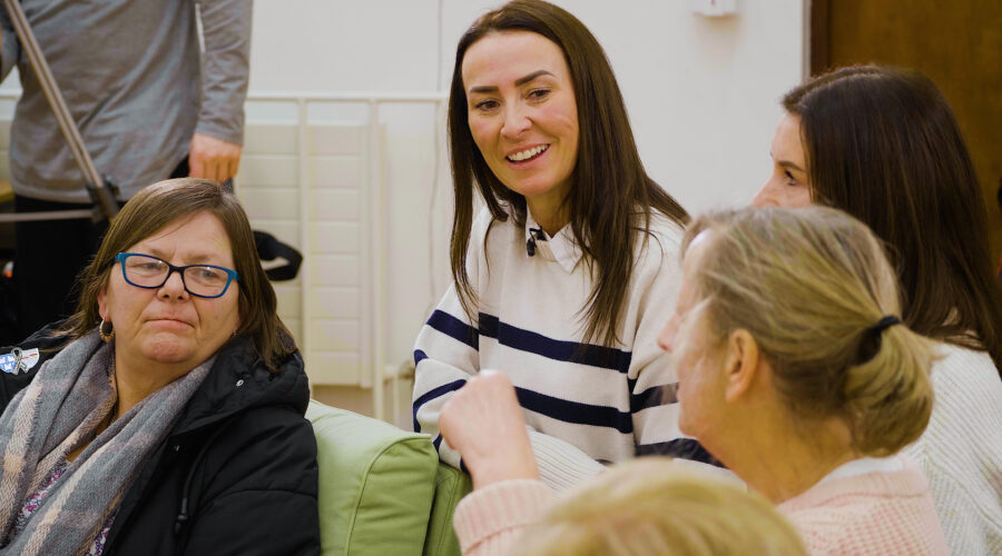 women talking and laughing in a meeting