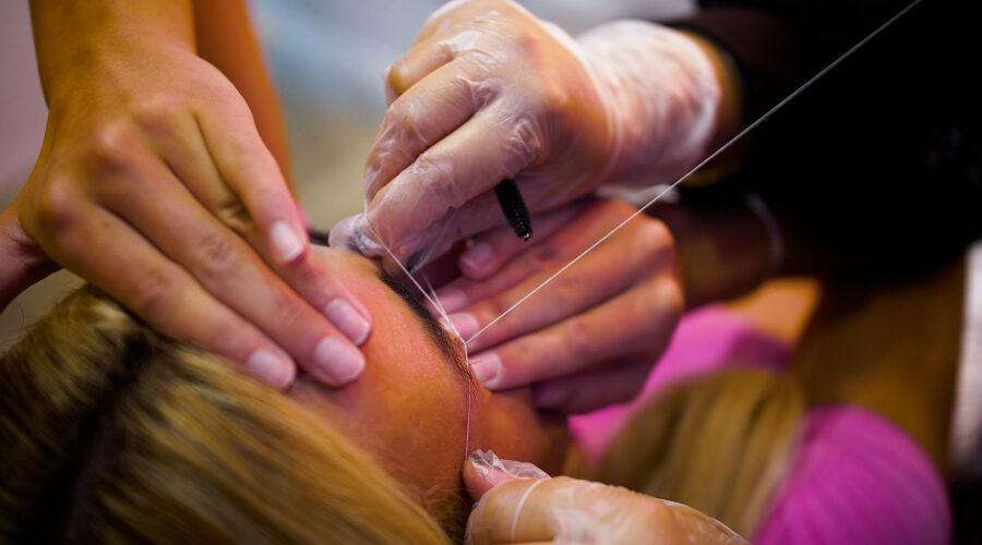 woman-having-eyebrows-threading