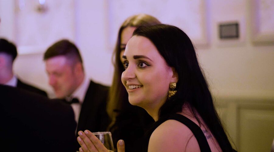 woman-smiling-at-black-tie-event