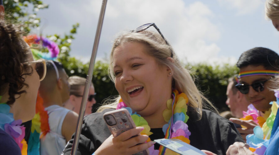 woman smiling and laughing at a pride parade event in Dublin