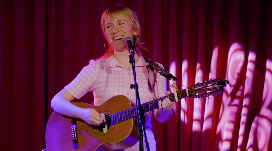 woman-smiling-with-guitar