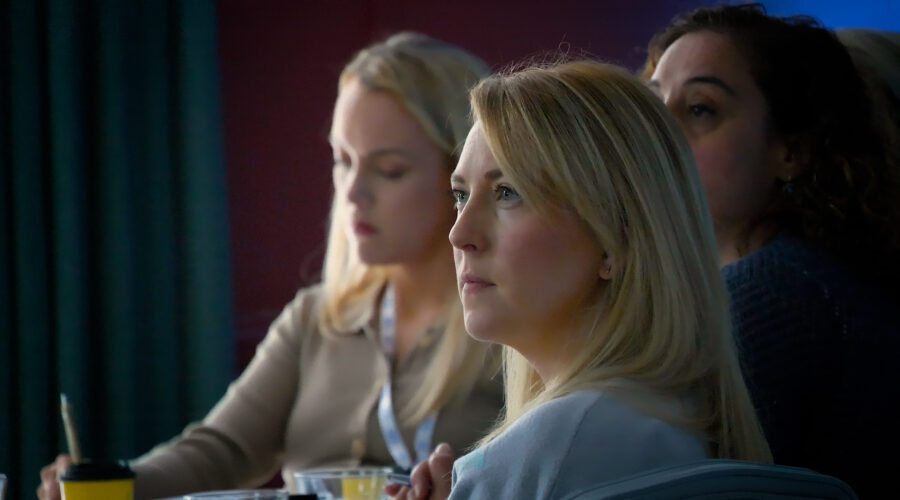 Women listening at conference event